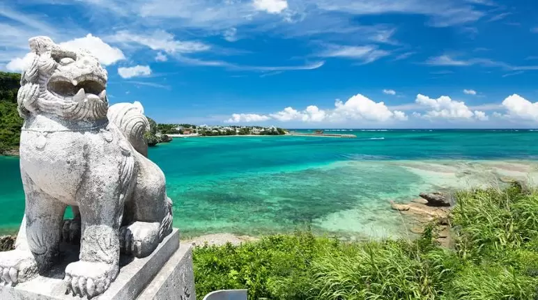 view of okinawa ocean with a shisa in the front