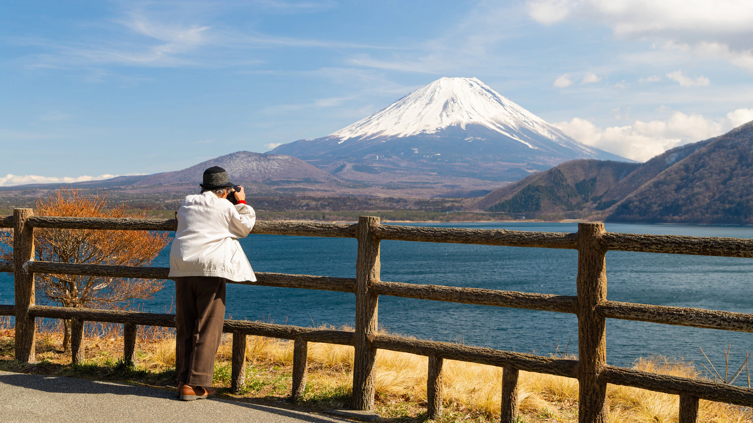person photographing Mount Fuji